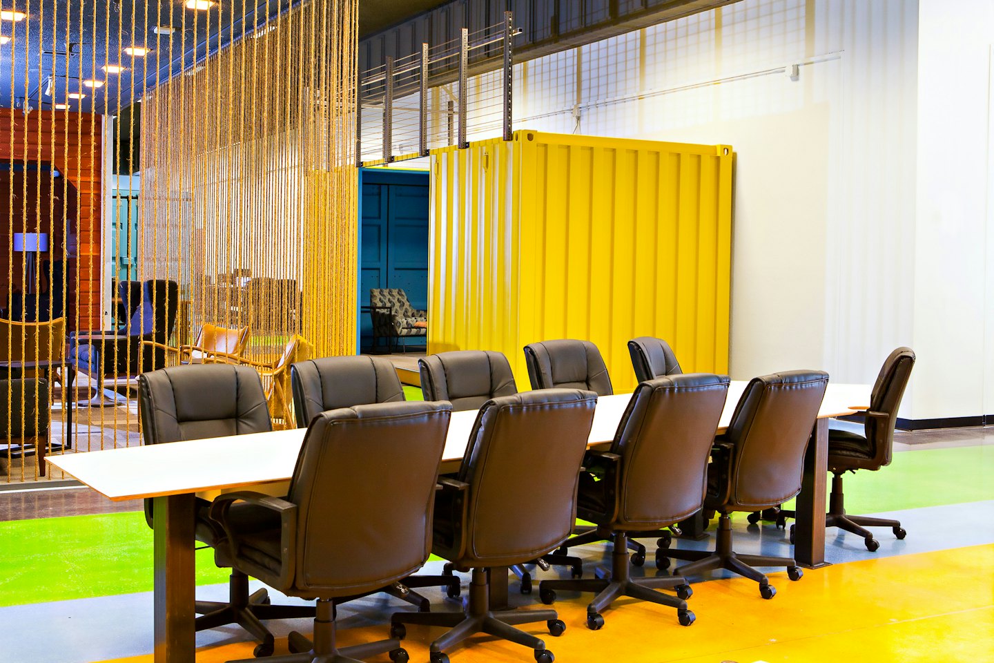 Modern office meeting room with yellow container wall.